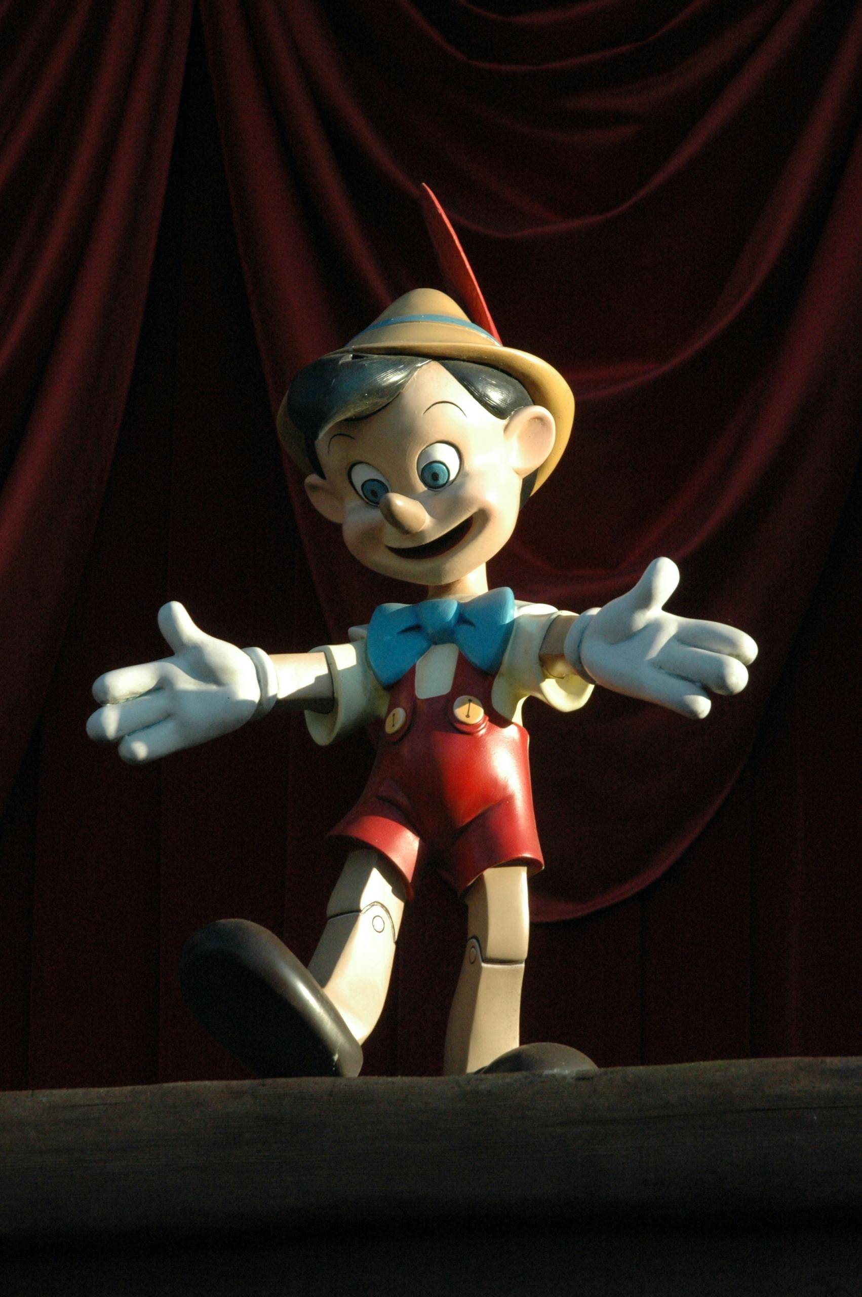 A wooden puppet with an exaggeratedly long nose, resembling Pinocchio, symbolizing dishonesty and deception. A simple yet powerful representation of a liar caught in the act